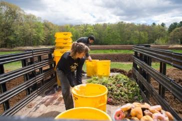 Students working with compost in the bed of a truck